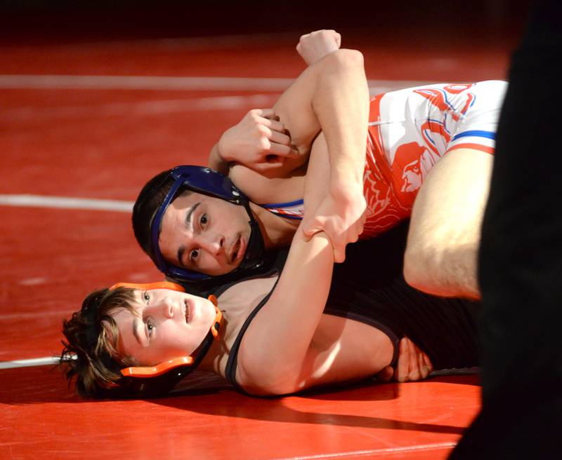 Oregon's Josiah Perez (top) looks at the clock as he wrestles a Sandwich opponent during the 113-pound match at a triangular meet with Morrison on Friday, Jan. 31, 2025 in the Blackhawk Center at Oregon High School.