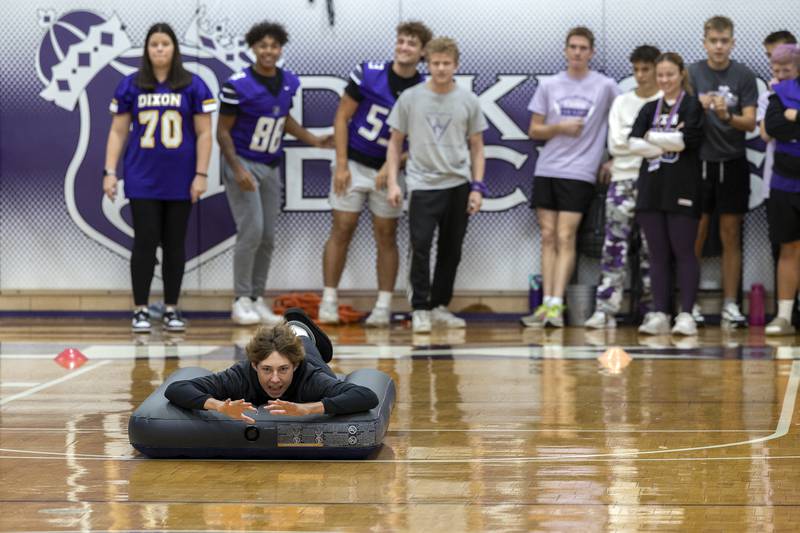 Seniors at Dixon High School compete in a game Friday, Sept. 27, 2024, during the homecoming pep rally. Students needed to run, dive and slide onto a mattress across the gym floor. First class across was the winner.