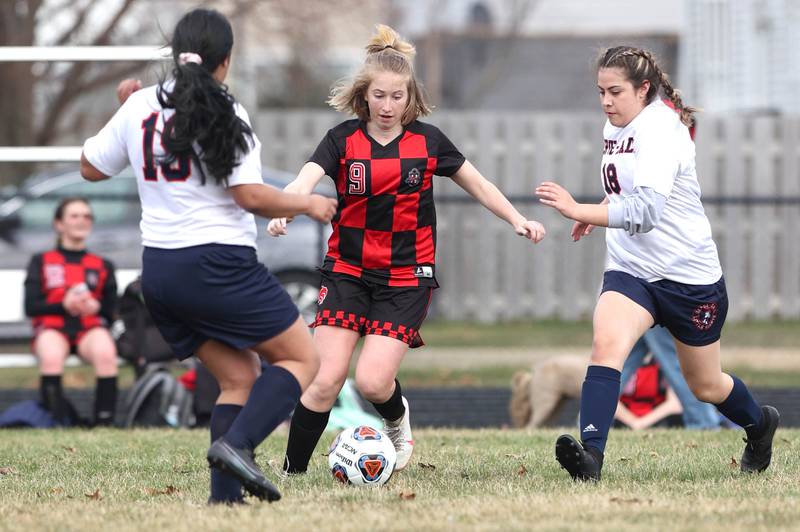 Indian Creek's Jolee Larson splits two DePue defenders during their game Tuesday, April 5, 2022, at Indian Creek Middle School in Waterman.