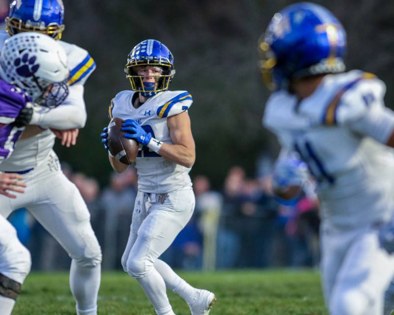 Moroa-Forsyth's Kaiden Maurer (22) looks for an open receiver during Class 2A semi-final playoff football game between Moroa-Forsyth at Wimington.  Nov 18, 2023.