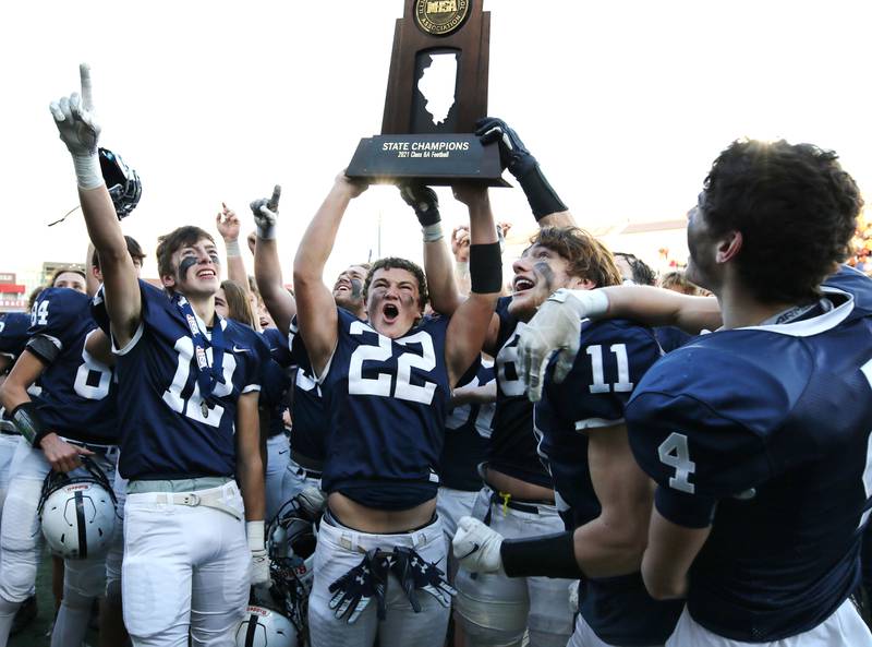 Cary-Grove players show off the state championship trophy to the student section after their 37-36 win over East St. Louis in the Class 6A state championship Saturday, Nov. 27, 2021, in Huskie Stadium at Northern Illinois University in DeKalb.