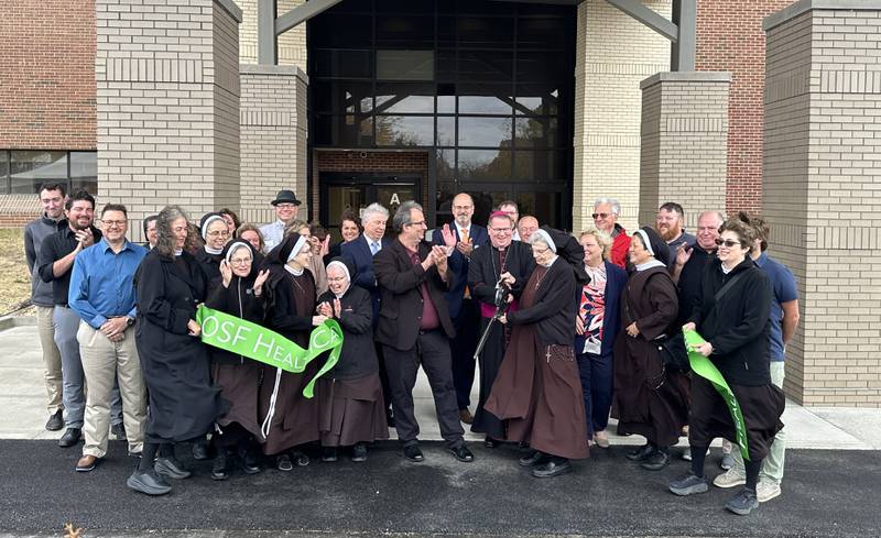 OSF and members of the community applaud during a ribbon-cutting ceremony of the outpatient entrance on Thursday, Oct. 31, 2024 at OSF HealthCare Saint Elizabeth Medical Center in Peru.