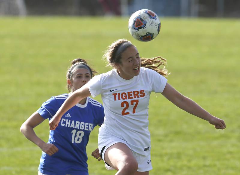 Crystal Lake Central's Sadie Quinn heads the ball in front of Dundee-Crown's Berkley Mensik during a Fox Valley Conference soccer match Tuesday April 26, 2022, between Crystal Lake Central and Dundee-Crown at Dundee-Crown High School.
