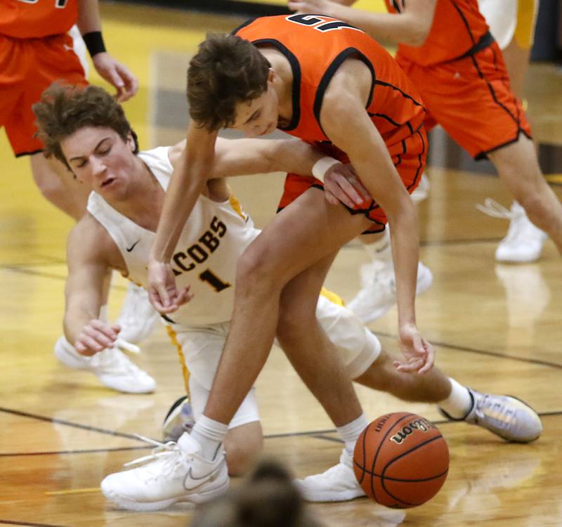 McHenry's Caleb Jett tries to grab a loose ball in front of Jacobs' Ben Jurzak during a Fox Valley Conference boys basketball game on Wednesday, Nov. 29, 2023, at Jacobs High School in Algonquin.