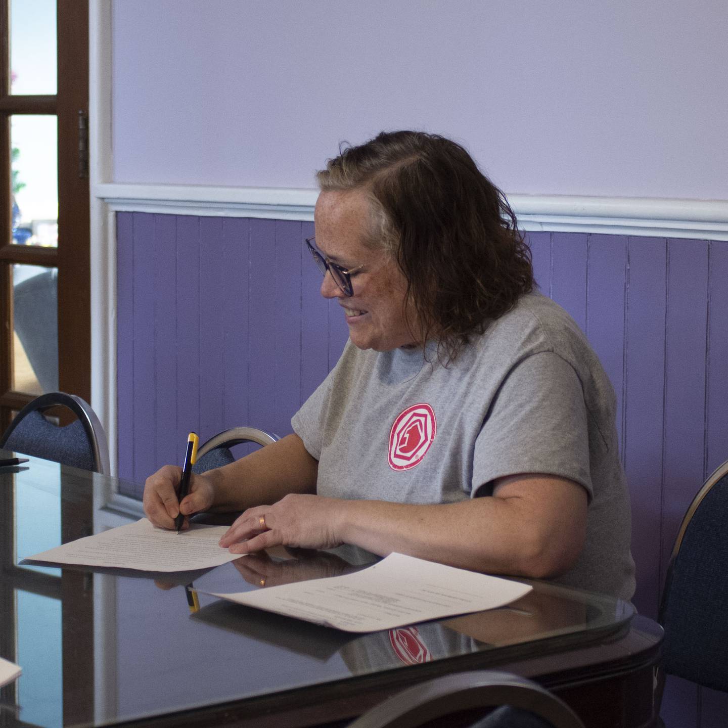 Jennifer Martin Olsen, moderator of Open Table United Church of Christ, signs sale/lease agreement with Ottawa Center for the Arts.