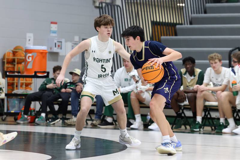 Bishop McNamara's Jayson Benton defends during the Fightin' Irish's 62-25 victory over Chesterton Academy on Wednesday, Jan. 7, 2026.