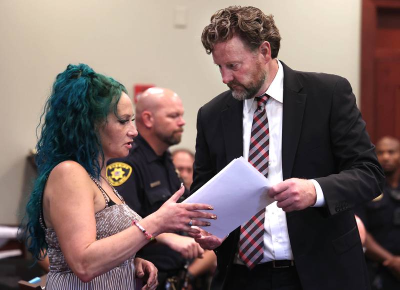 Ericka Sasso, mother of Gracie Sasso-Cleveland who was murdered by Timothy Doll in 2023, talks to lead prosecutor Scott Schwertley before making her victims impact statement Thursday, Aug. 14, 2025, during Doll’s sentencing hearing at the DeKalb County Courthouse in Sycamore. Doll was sentenced to 52 years in prison.