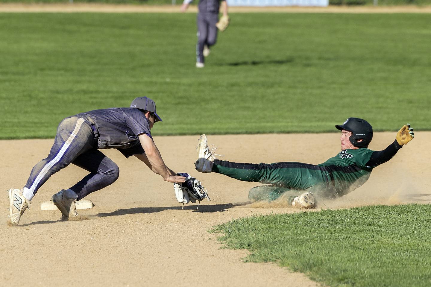 Dixon’s Jake Zepezauer tags out Rock Falls’ Carter Hunter stealing second Tuesday, April 29, 2025.