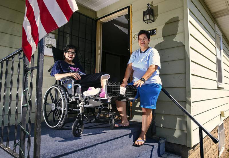 Angie Sanchez and her mother, Debbie Robertson, are seen on their front porch last summer.