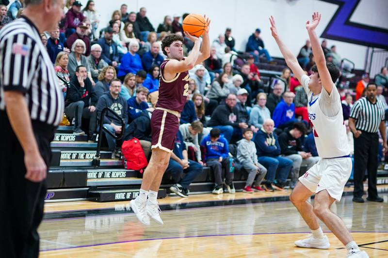 Morris’ Ximi Baftiri (21) shoots a three pointer against Marmion during a basketball game in the opening round of the 61st annual Plano Christmas Classic at Plano High School on Monday, December 23, 2024.