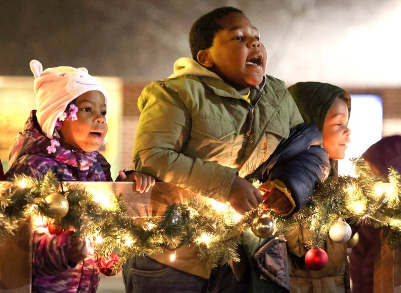 Kids sing carols as they wait for Santa at the Santa house near the Egyptian Theatre Thursday, Dec. 1, 2022, during the DeKalb Chamber of Commerce Lights on Lincoln and Santa Comes to Town.