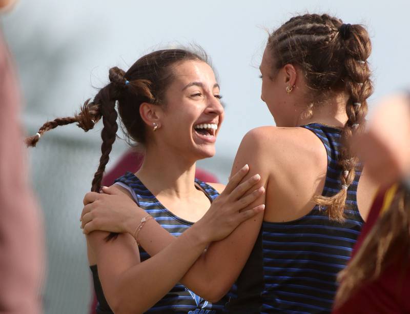 Woodstock’s Sophia Mendoza, left, celebrates after her long jump in IHSA Class 2A Girls Sectional Track action at Genoa-Kingston School in Genoa on Friday, May 16, 2025.