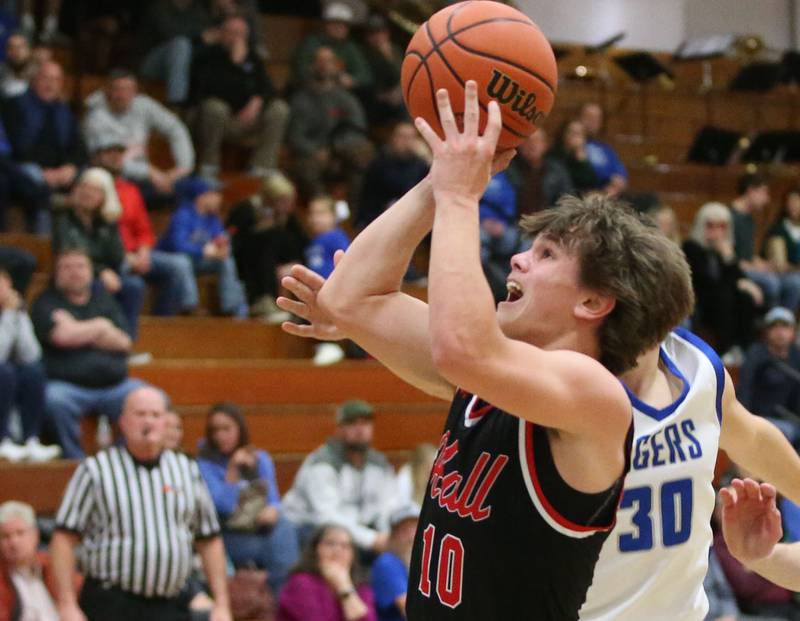 Hall's Greyson Bickett eyes the hoop over Princeton's Sean Maynard on Friday, Jan. 26, 2024 at Princeton High School.