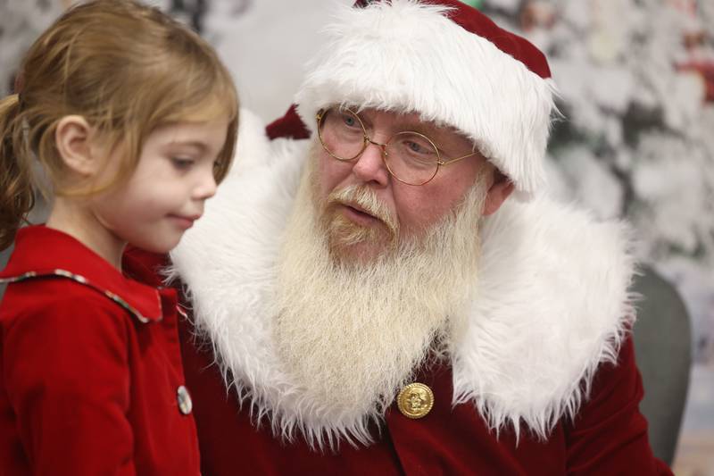 Santa talks to Scarlett Szafranowski, 4, at the Shorewood-Troy Public Library.