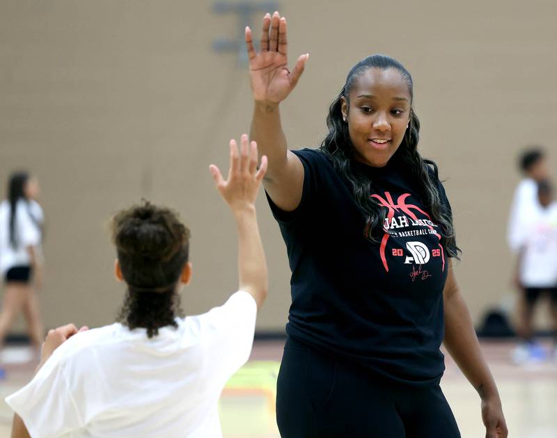 DeKalb native and former Northern Illinois University basketball player A'Jah Davis gives a high-five during a drill Saturday, May 24, 2025, at her A'Jah Davis Foundation Basketball Camp and Wellness Day at DeKalb High School.