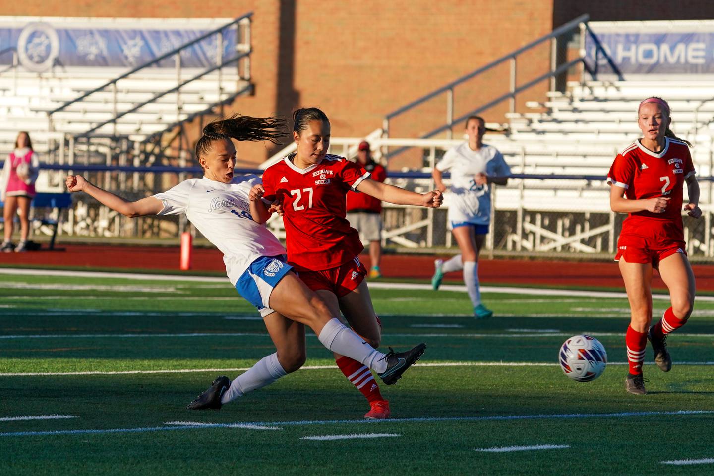 St. Charles North's Laney Stark (19) shoots the ball for a goal against Naperville Central's Malia Shen (27) during a Class 3A St. Charles North Supersectional soccer final match at St. Charles North High School on Tuesday, May 28, 2024.