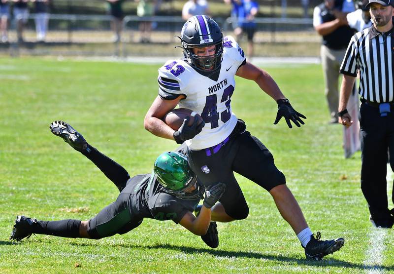 Downers Grove North tight end Robert Farrington III (43) drags Glenbard West tackler Val Jones near the sideline during a game on Sep. 9, 2023 at Glenbard West High School in Glen Ellyn.
Jon Cunningham for Shaw Local News Network