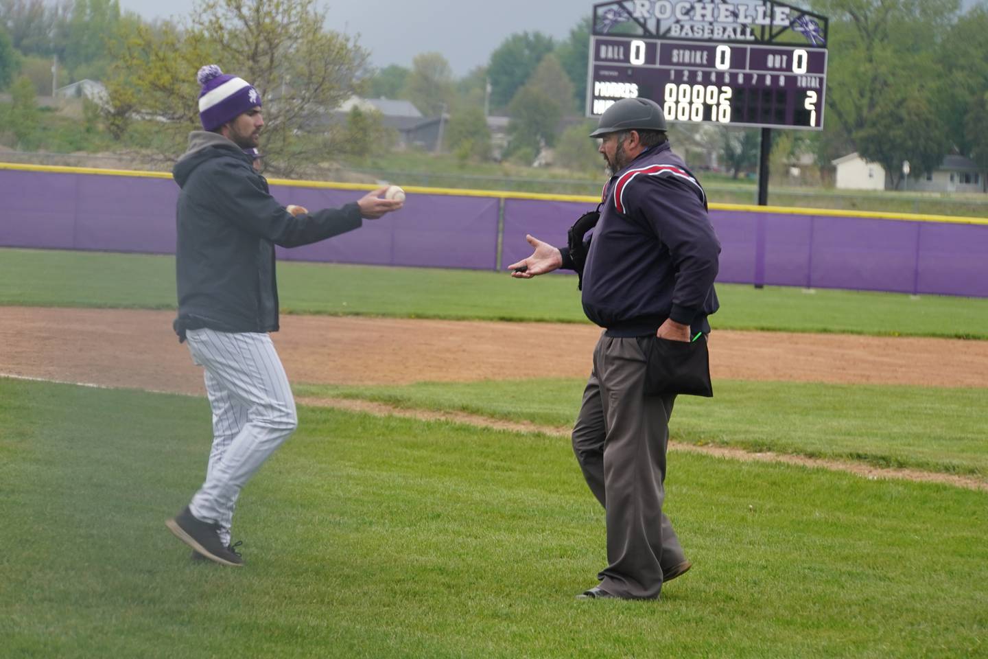 Rodger Griffith (right) takes a ball from a coach at a baseball game at Rochelle Township High School on Thursday, April 30, 2026.