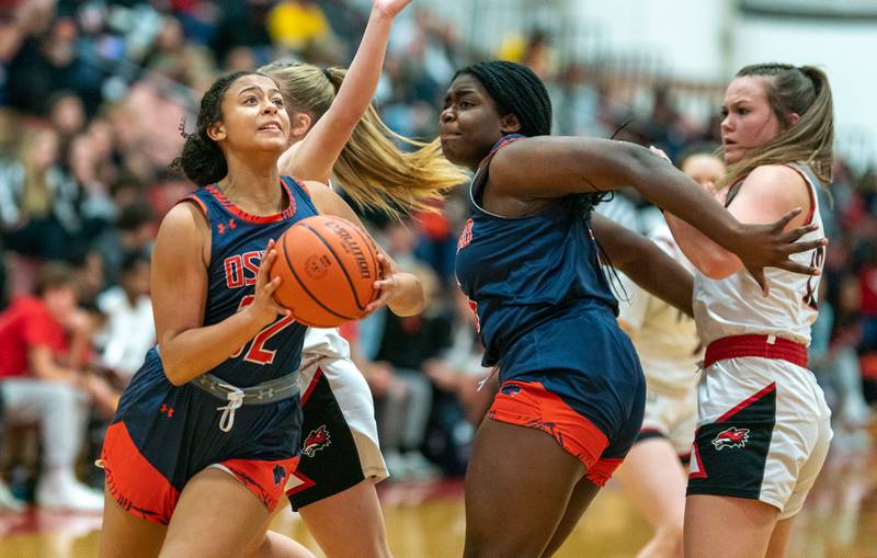 Oswego’s Ahlivia East (32) drives to the basket against Yorkville during the 13th annual Hoops 4 Hope Communities vs. Cancer basketball event at Yorkville High School on Saturday, Jan 28, 2023.