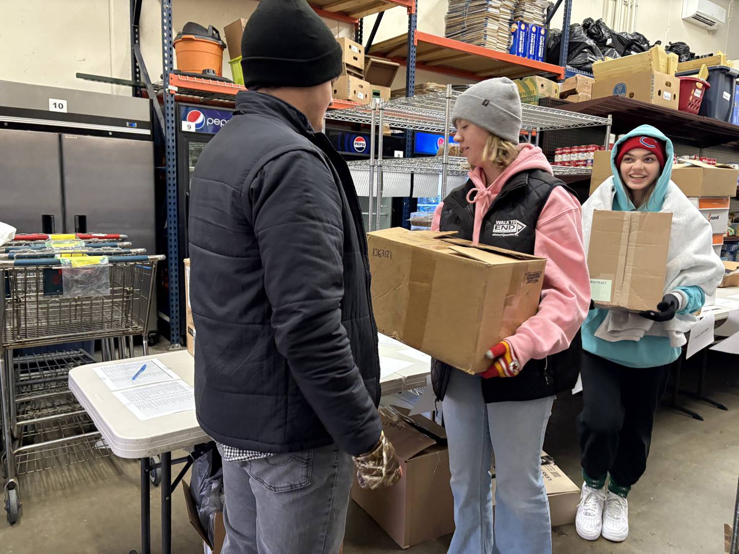 Huntley High students sort donations at the Grafton food pantry in Huntley Dec. 11, 2024.