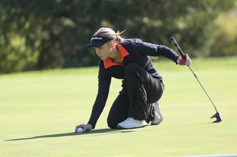 Plainfield East’s Hope Trosclair lines up a putt on the six hole at the Plainfield North Class 2A Regionals onTuesday, Oct. 1, 2024 at Whitetail Ridge Golf Course..