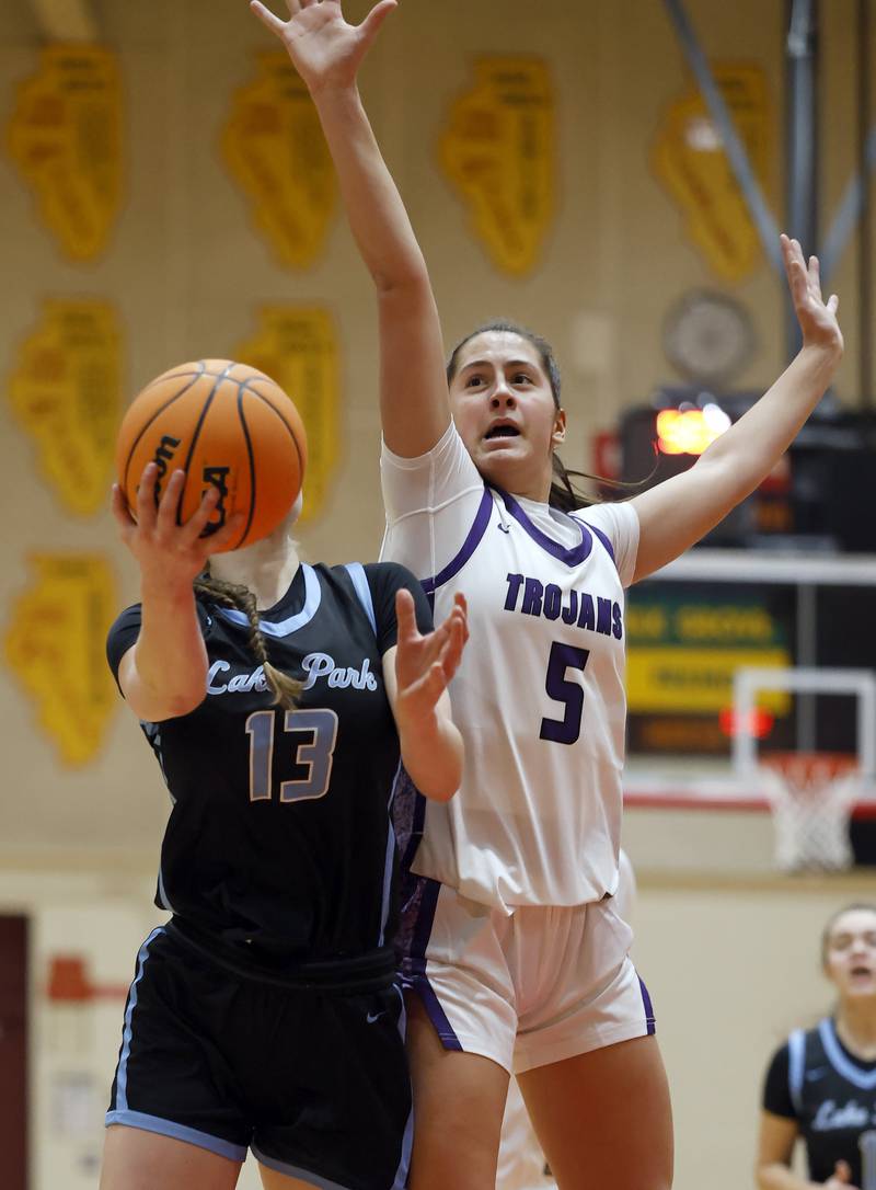 Lake Park's Allison Gogola (13) goes to the hoop as Downers Grove North's Campbell Thulin (5) attempts to block her shot during the Schaumburg High School Lady Saxons Thanksgiving Basketball Tournament Friday, Nov. 28, 2025 in Schaumburg.