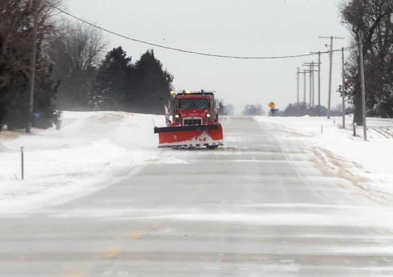 A La Salle County snowplow plows through snow drifts on North 33rd Road near Dimmick on Thursday, Feb. 3, 2022. Rural east and west roads are causing minor blowing and drifting snow.