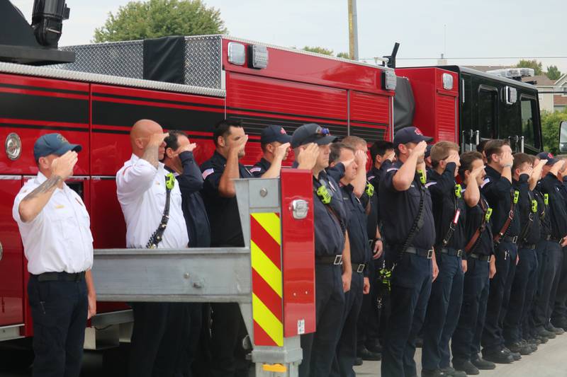 Members of the DeKalb Fire Department give a salute to the American flag Thursday, Sept. 11, 2025, during the fire department's annual Patriot Day Ceremony.