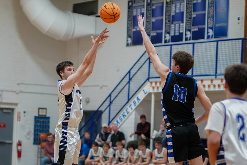 Newark’s Payton Wills (15) shoots a three pointer over Hinckley-Big Rock's Max Hintzsche (10) during a basketball game at Newark High School on Tuesday, January 28, 2025.