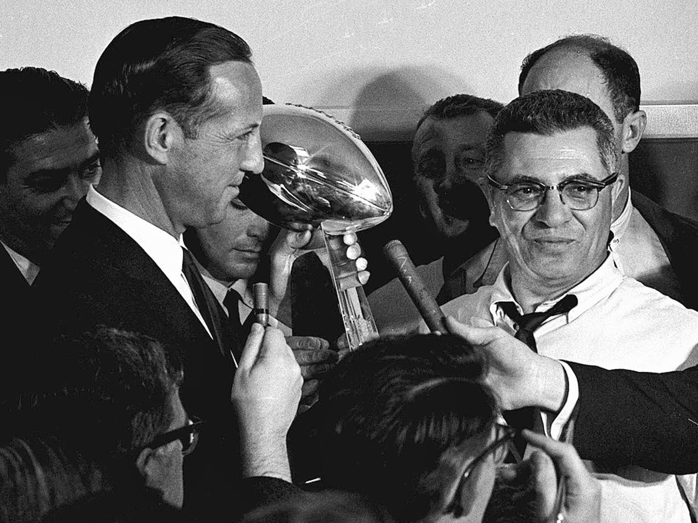 Football commissioner Pete Rozelle (left) presents the trophy to Green Bay Packers coach Vince Lombardi after they beat the Kansas City Chiefs in the Super Bowl in Los Angeles, Jan. 15, 1967. The trophy for the Super Bowl winner has borne Lombardi's name since his death in 1970.