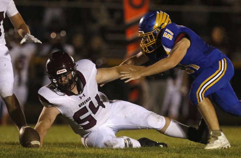 Marengo’s Lucas Grimaudo tries to get his hand under the football as he tries to intercept a pass in front of Johnsburg's Andrew Morris during a Kishwaukee River Conference football game on Friday, Sept. 15, 2023, at Johnsburg High School.