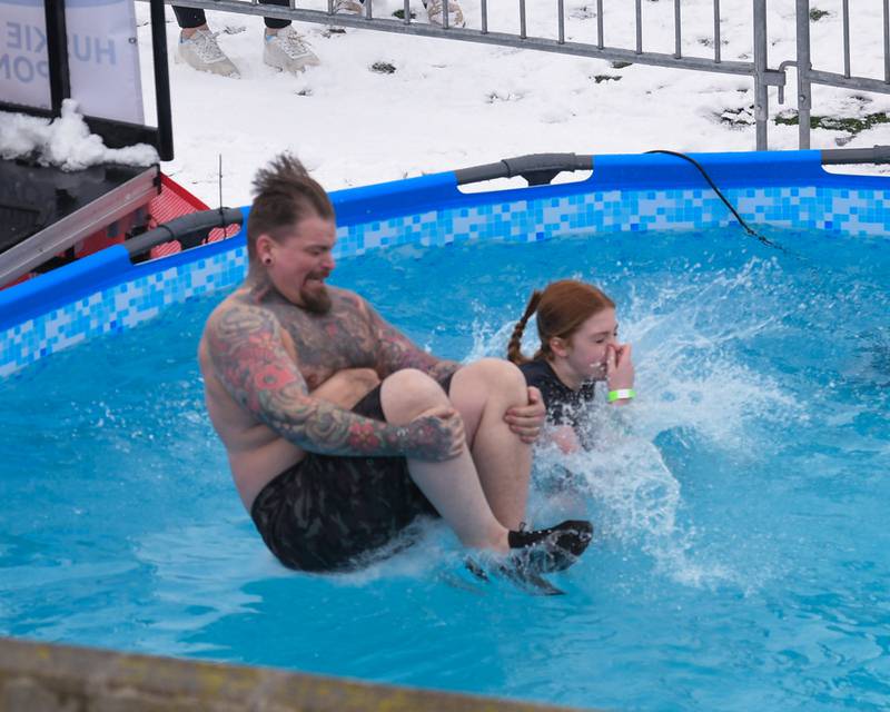 A participant performs a canon ball jump into the pool on Saturday, Feb. 15, 2025, during the 2nd annual Polar Plunge at Northern Illinois University's Huskie Stadium in DeKalb. Proceeds benefited the law enforcement torch run for Special Olympics.