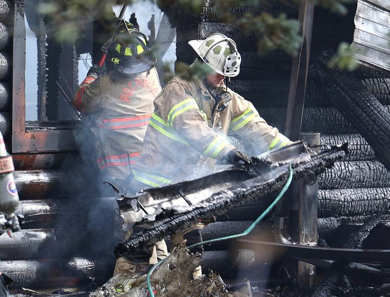 Rochelle firefighters pull debris from a house that was destroyed by fire Thursday, Nov. 13, 2025, near Shabbona Grove Road in Shabbona. Several local departments responded to the general alarm structure fire.