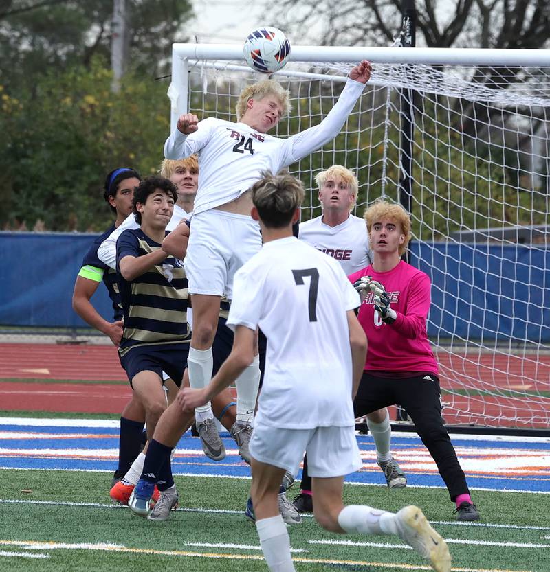 Prairie Ridge's Carter Fredrikson heads the ball away from Lemont players in front of his goal Saturday, Nov. 9, 2024, during their Class 2A state third place game at Hoffman Estates High School.