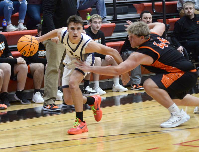 Polo's Gus Mumford (5) drives to the basket as Warren's Bryce Long tries to get a hand on the ball during a Tuesday, Dec. 17, 2024 game at the 63rd Annual Forreston Holiday Tournament.