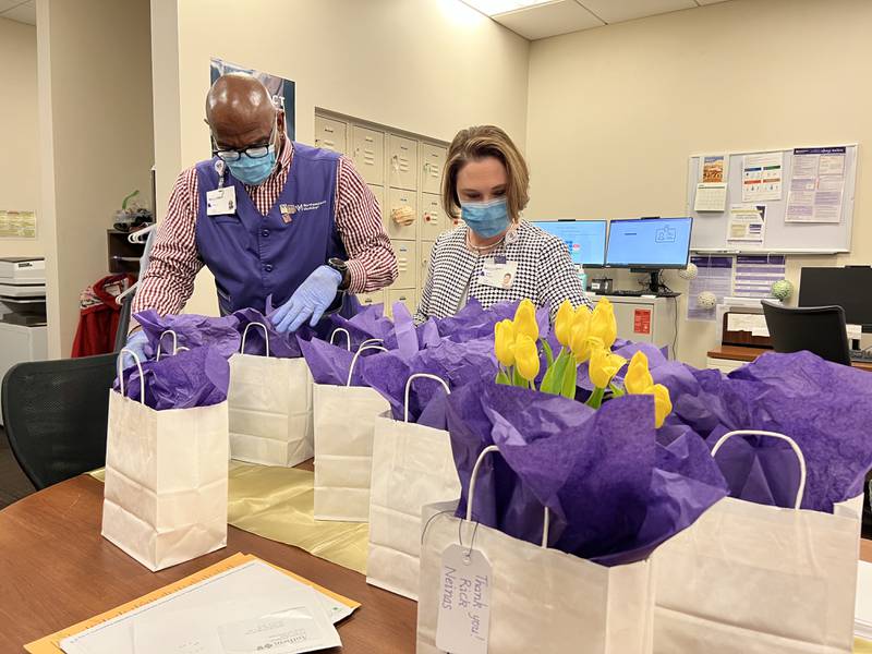 Northwestern Medicine Delnor Hospital volunteer Ivory Daniels (left) helps Volunteer Services Coordinator Kelli Bender prepare gift bags for volunteers during National Volunteer Week.