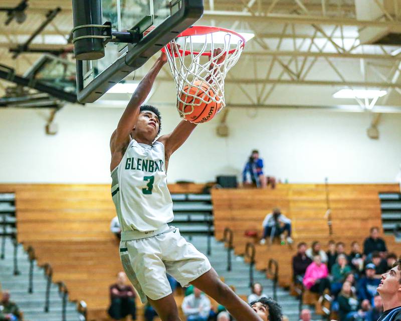 Glenbard West's TJ Williams (3) dunks during their Jack Tosh Holiday Classic basketball tournament game between Nazareth vs Glenbard West. Thursday Dec 26, 2024 in Elmhurst.