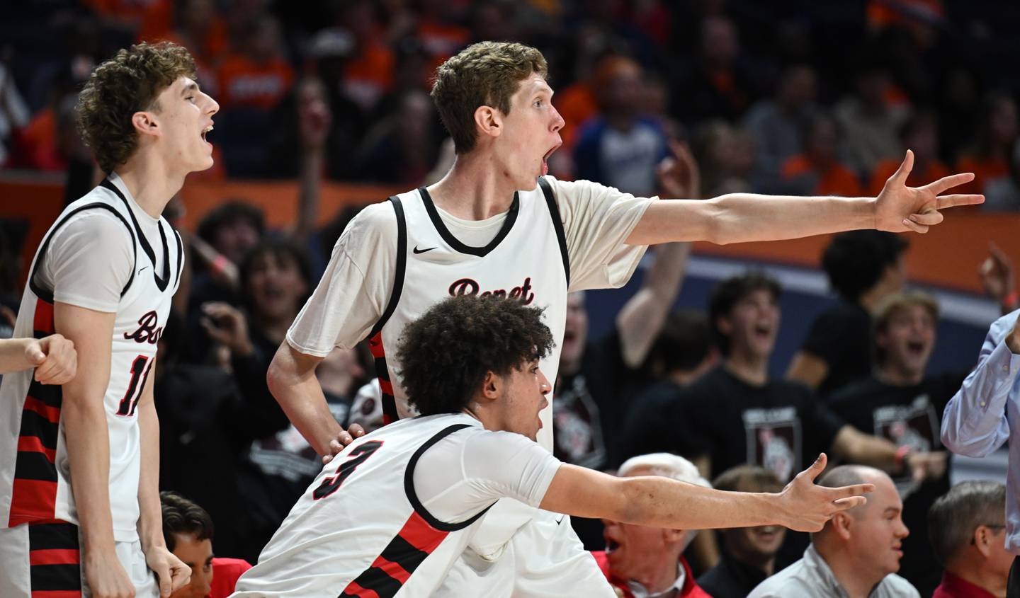 Benet Academy's Grant Bergmann, left, Jayden Wright, front,  and Colin Stack celebrate a basket by a late-game substitute during the IHSA Class 4A boys basketball state semifinals at State Farm Center on Friday, March 14, 2025 in Champaign.