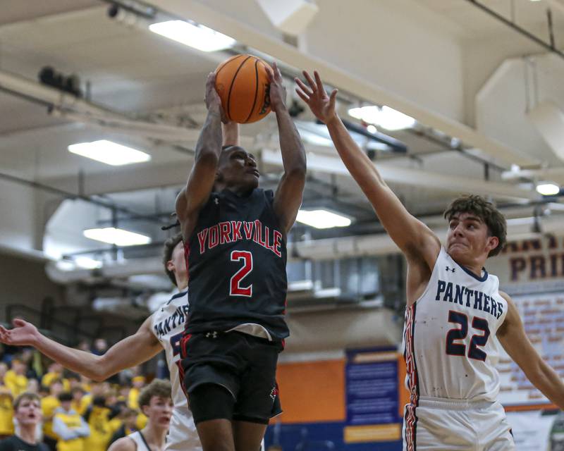 Yorkville's Alonn Flint (2) puts up a shot over Oswego's Luke Roller (22) during their basketball game between Yorkville at Oswego, Feb 7, 2026 in Oswego.