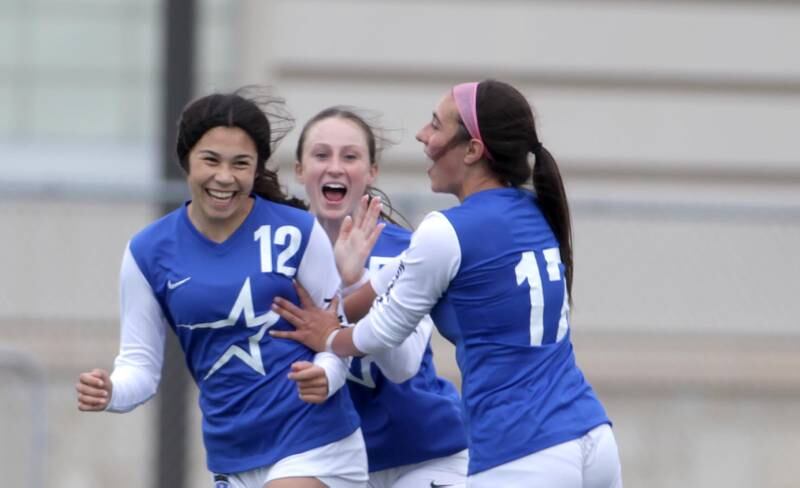 (Left to right) St. Charles North players Juliana Park, Rian Spaulding and Bella Najera celebrate a goal by Park during at Tri-Cities Night game against St. Charles East at Batavia High School on Tuesday, May 2, 2023.