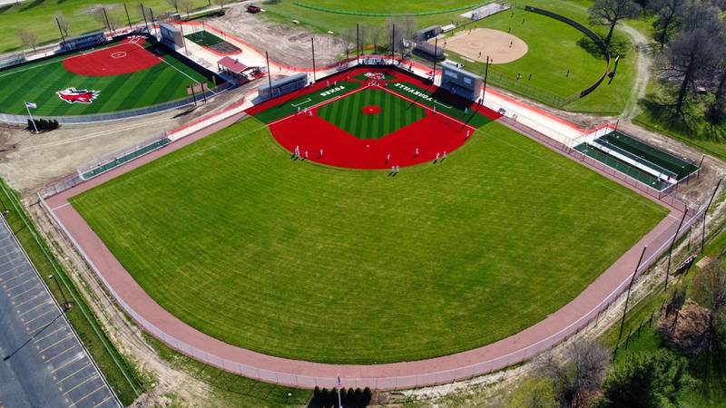 Yorkville baseball players warm up on their new turf baseball field prior to the start of their game against West Aurora at Yorkville High School on Monday, April 15, 2024.