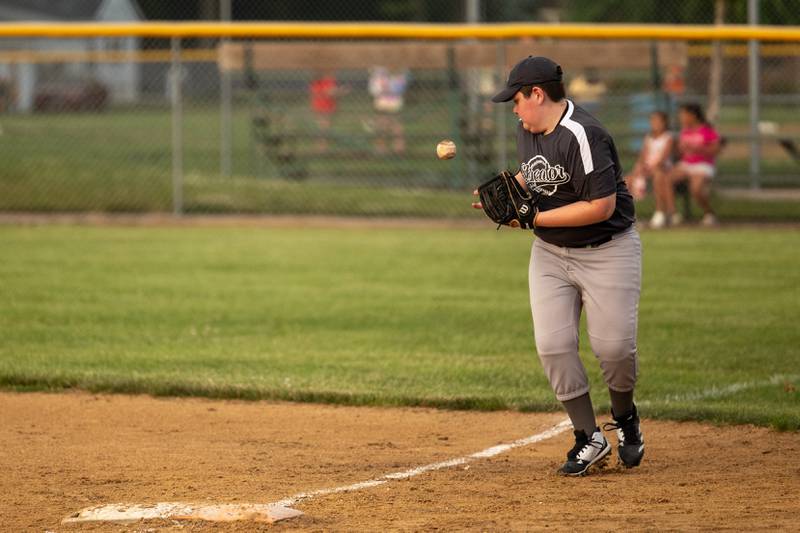 Isaac Brockman (12) of Winterrowd Funeral juggles a grounder at first base Wednesday, June 25, 2025, at Southside Park in Streator.