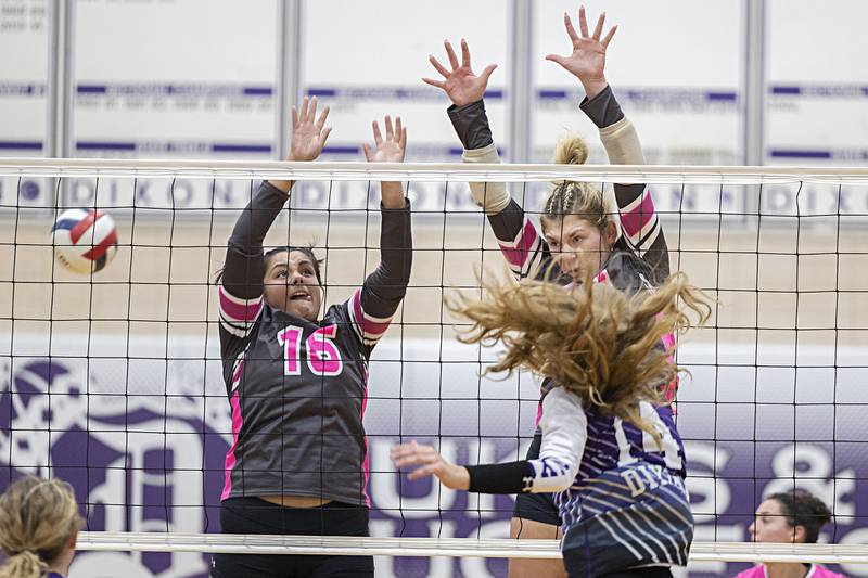 Rock Falls’ Taylor Reyna (left) and Claire Bickett go up to block a shot by Dixon’s Leah Carlson Thursday, Oct. 12, 2023 at Dixon High School.