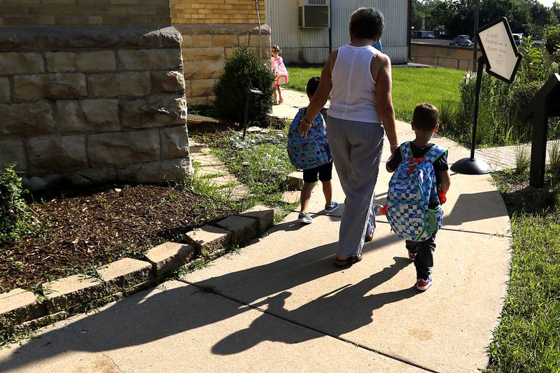 Landmark Principal Margaret Carey walk students to the meeting area before the first day of school for McHenry's Landmark Elementary School on Wednesday, July 17, 2024.