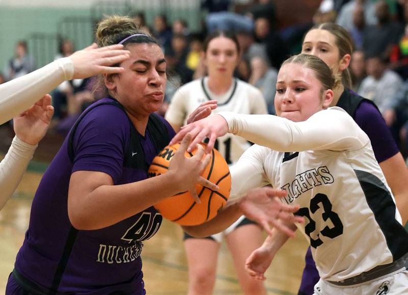 Dixon’s Hallie Williamson and Kaneland's Kendra Brown fight for a loose ball during their Class 3A sectional semifinal game Tuesday, Feb. 25, 2025, at Boylan Catholic High School in Rockford.
