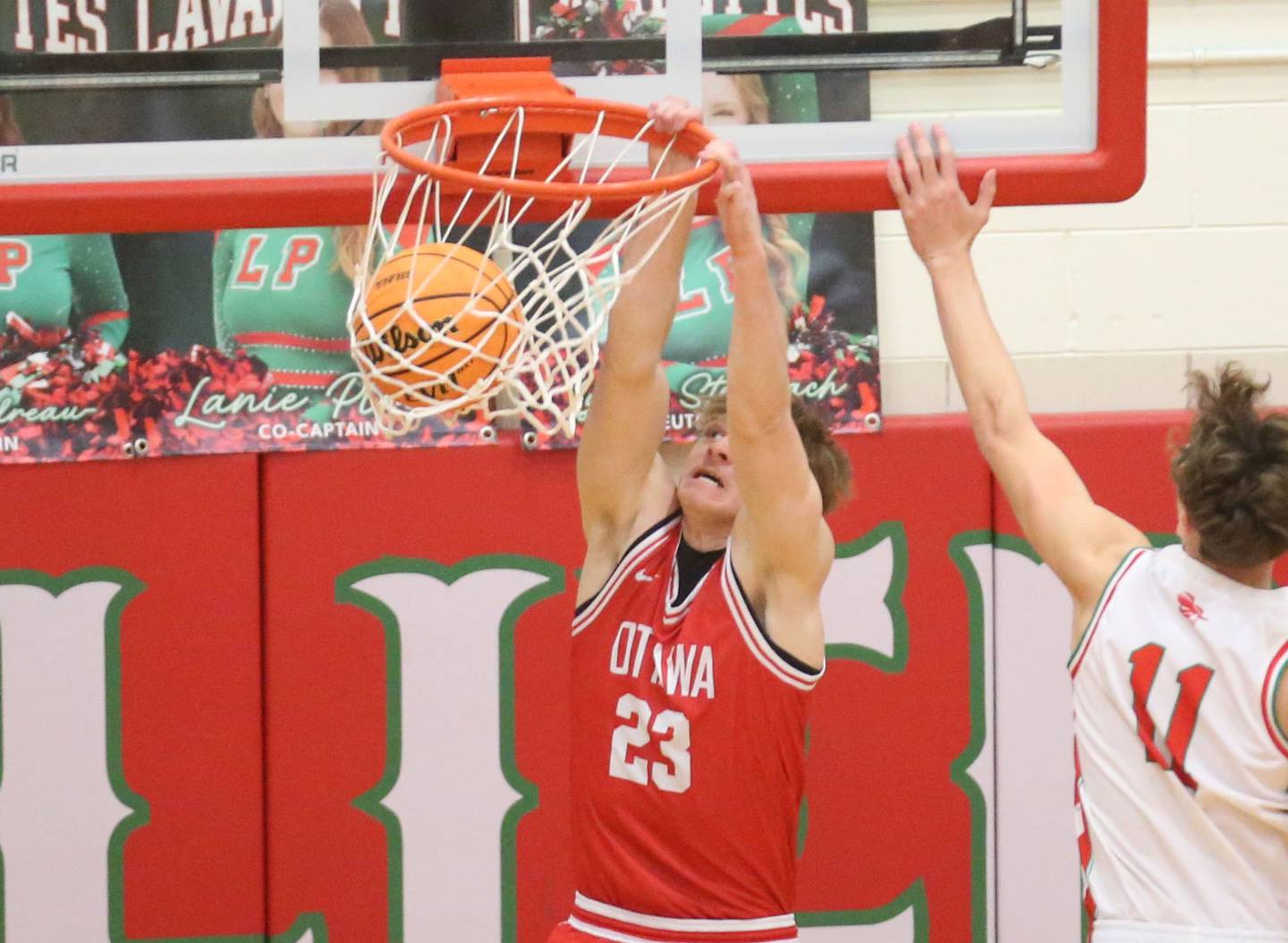 Ottawa's Owen Sanders dunks the ball over L-P's Jameson Hill during the Class 3A Regional title game on Wednesday, Feb. 25, 2026 in Sellett Gymnasium at L-P High School.
