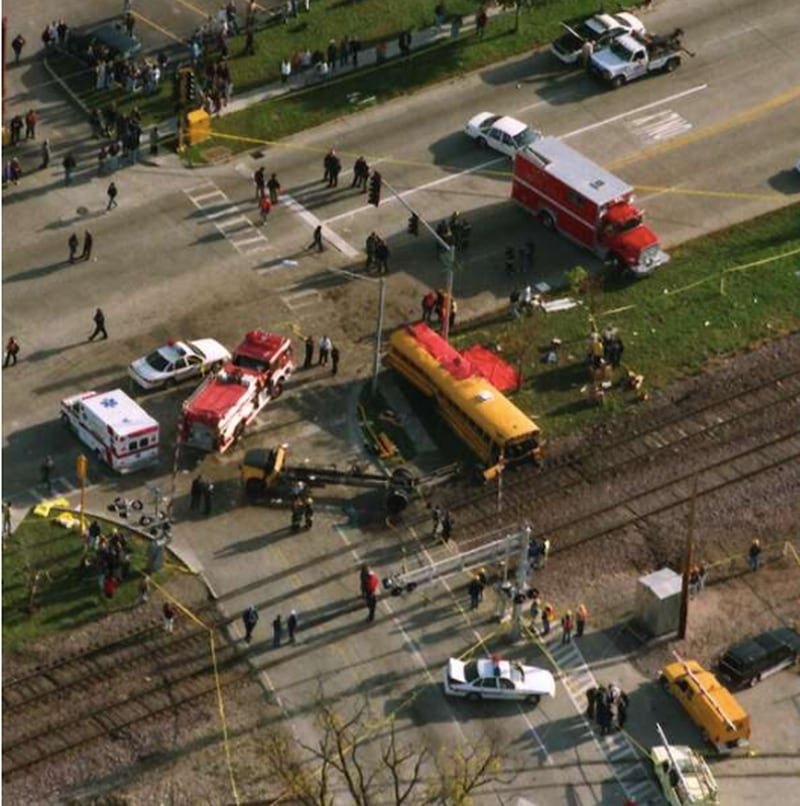 First responders arrived to a deadly crash scene the morning of Oct. 25, 1995, after a train struck a school bus in Fox River Grove. A memorial for the seven Cary-Grove High School students who died now marks the location at Algonquin Road and Northwest Highway. Daily Herald File Photo, 1995