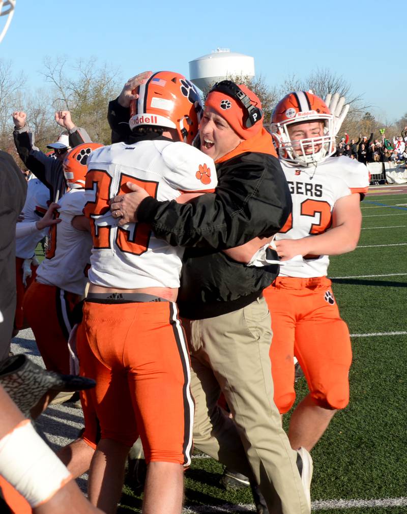 Byron's head coach, Jeff Boyer, celebrates with senior Everett Wichman (25) in the final seconds of the Tigers' win over Lombard-Montini during 3A football semifinal action in Lombard on Saturday, Nov. 18, 2023.