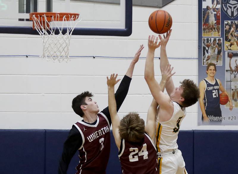 Crystal Lake South's Colton Hess (right) shoots the ball over Wheaton Academy's Alex Moncau (left) and Sam Swoboda during the IHSA Class 3A Cary-Grove Boys Basketball Regional Championship game on Friday, Feb. 23, 2024 at Cary-Grove High School.