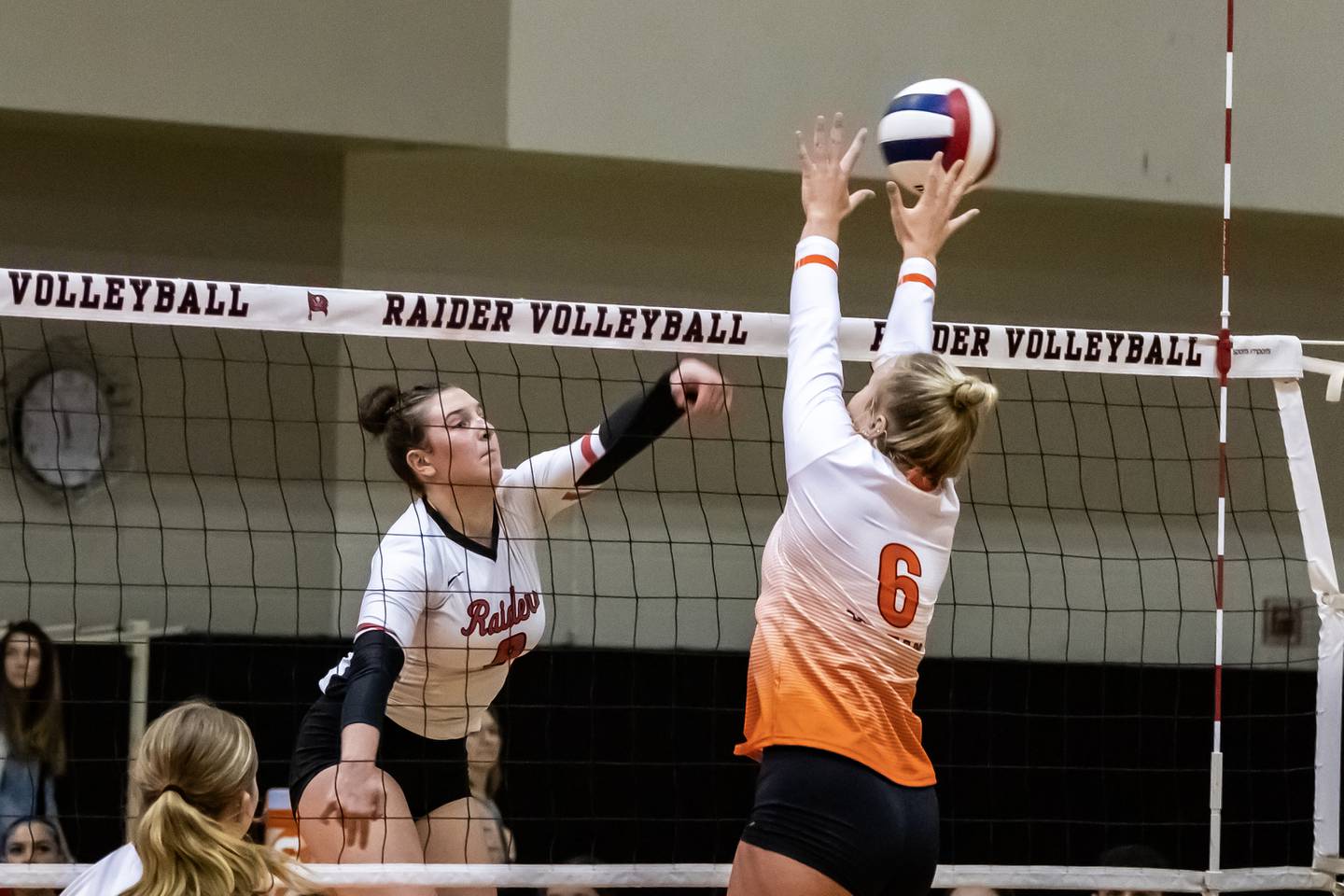Bolingbrook's Noelle Aprati goes for the kill as Minooka's Kendall Kozak attempts to block during a varsity volleyball game at Bolingbrook on Sept. 25, 2025.
